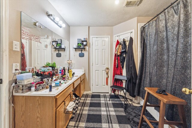 bathroom featuring vanity and a textured ceiling