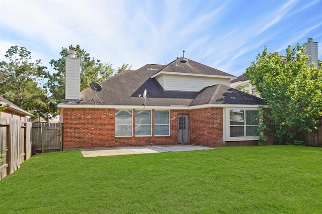 back of property featuring a patio, a lawn, brick siding, and a fenced backyard