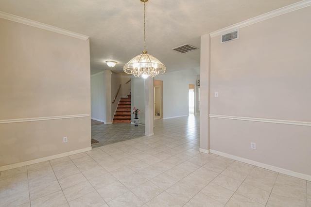 spare room with crown molding, a notable chandelier, and light tile patterned flooring