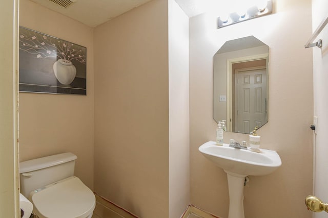 bathroom with toilet and sink