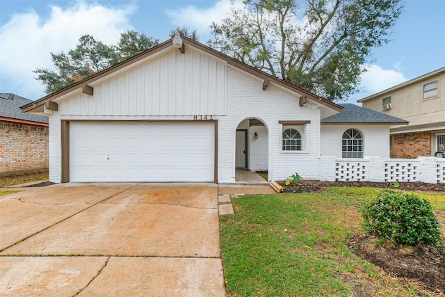 ranch-style house with a garage and a front lawn