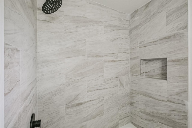 bathroom with tiled shower