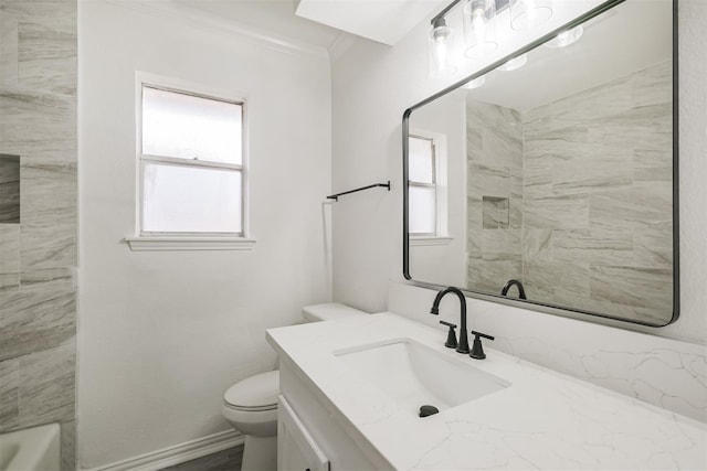 bathroom with ornamental molding, toilet, and vanity