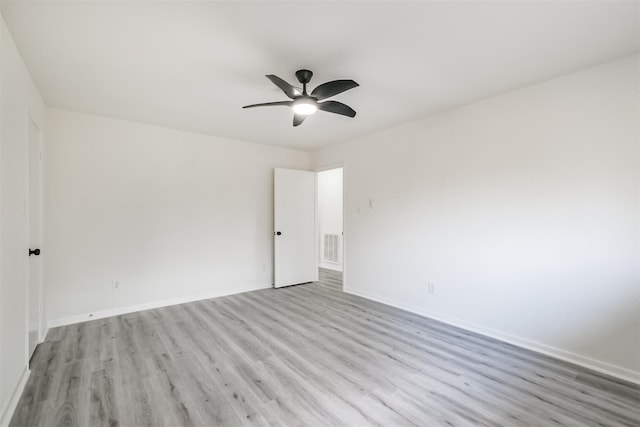 empty room featuring ceiling fan and light hardwood / wood-style flooring