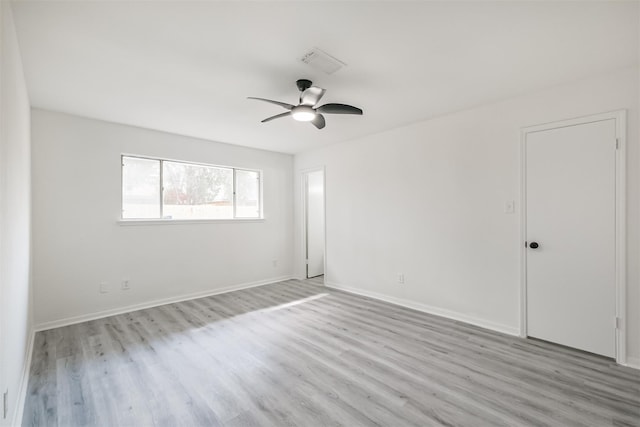 spare room featuring light hardwood / wood-style floors and ceiling fan