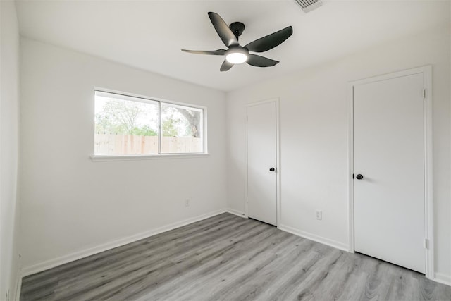 unfurnished bedroom with light hardwood / wood-style floors and ceiling fan