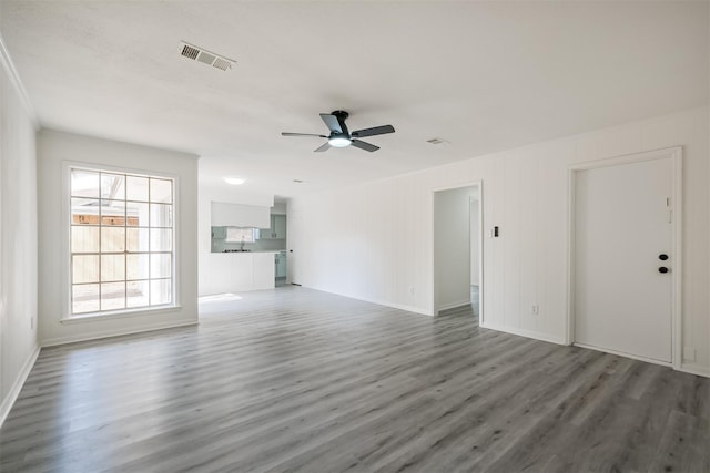 unfurnished living room featuring dark hardwood / wood-style flooring and ceiling fan