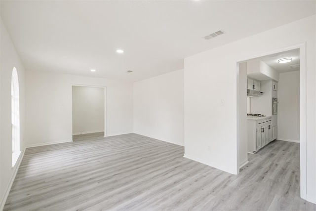 empty room with light hardwood / wood-style flooring