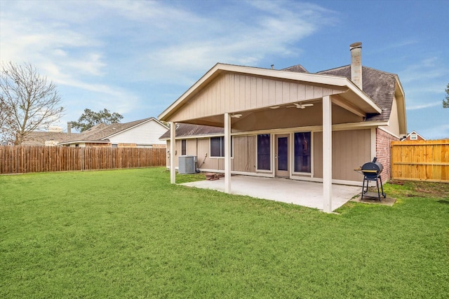 back of house with a yard, central AC unit, a patio area, and ceiling fan