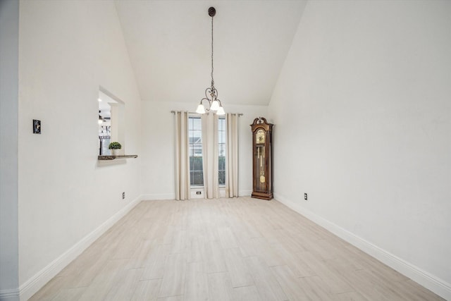 interior space featuring light hardwood / wood-style flooring, high vaulted ceiling, and a notable chandelier