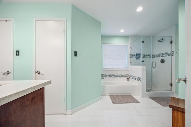 bathroom with plus walk in shower, vanity, and tile patterned floors