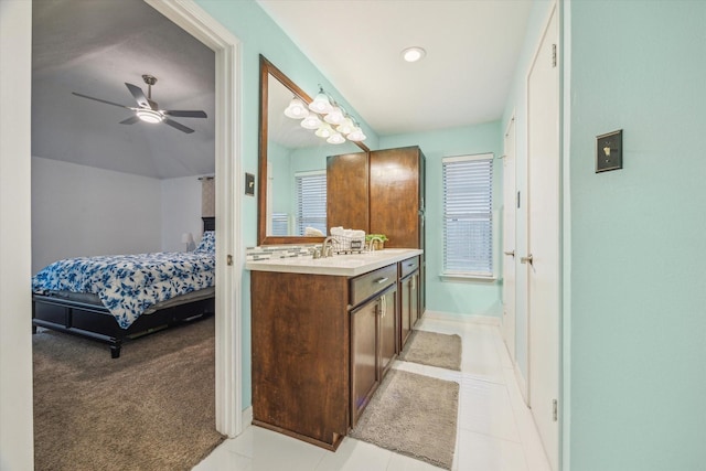 bathroom with tile patterned flooring, ceiling fan, and vanity