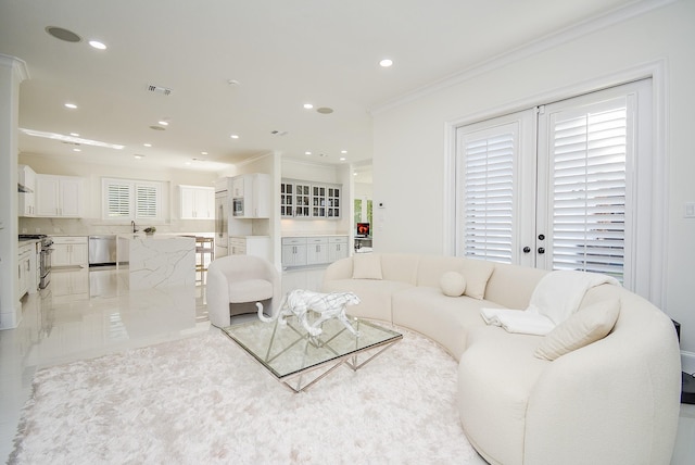 living room with ornamental molding and sink