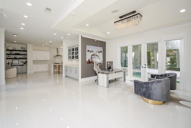 tiled living room with crown molding and french doors