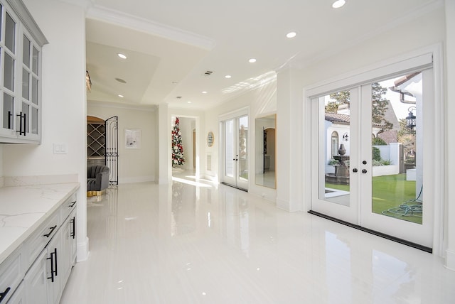 interior space featuring crown molding, french doors, and light tile patterned flooring