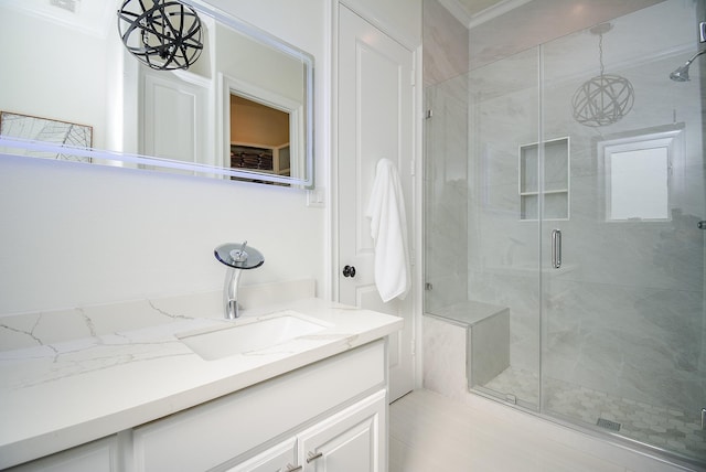 bathroom with vanity and a shower with door