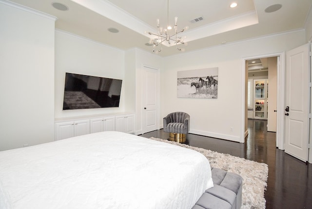 bedroom with a raised ceiling, crown molding, and dark hardwood / wood-style floors