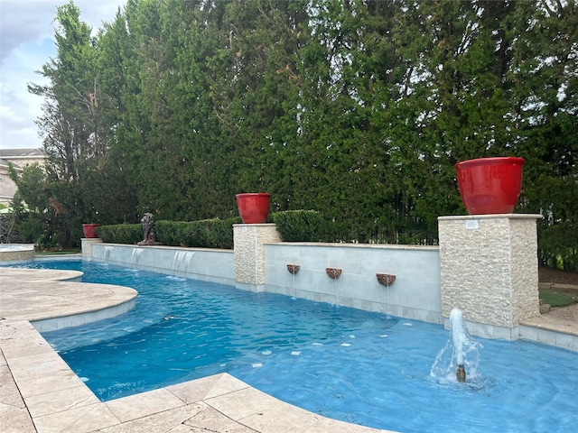 view of swimming pool featuring pool water feature