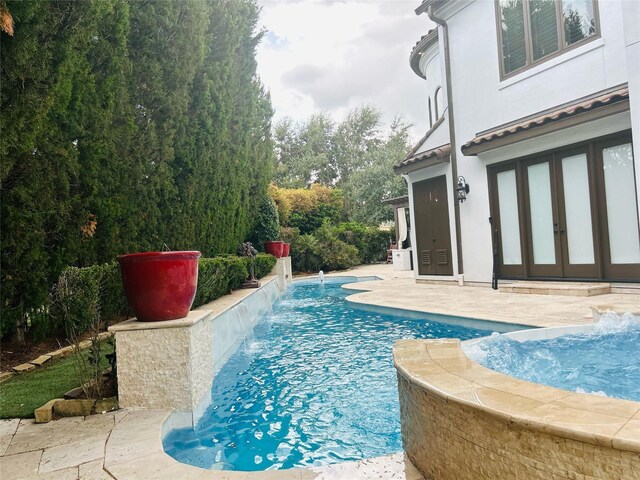 view of pool with a patio area and pool water feature