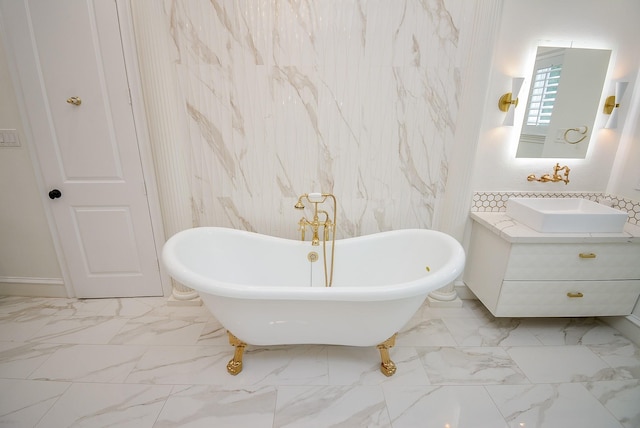 bathroom with a tub to relax in and sink