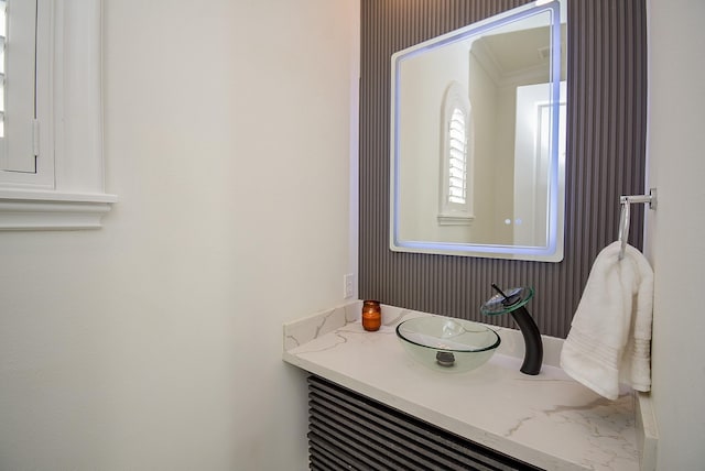 bathroom with ornamental molding and vanity