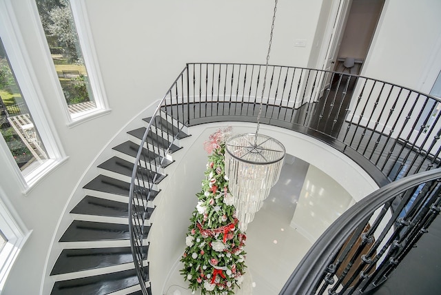 stairway with an inviting chandelier