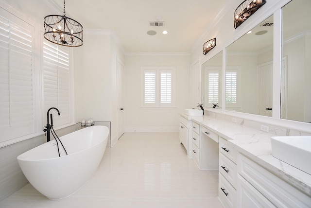 bathroom with crown molding, a notable chandelier, vanity, and a tub