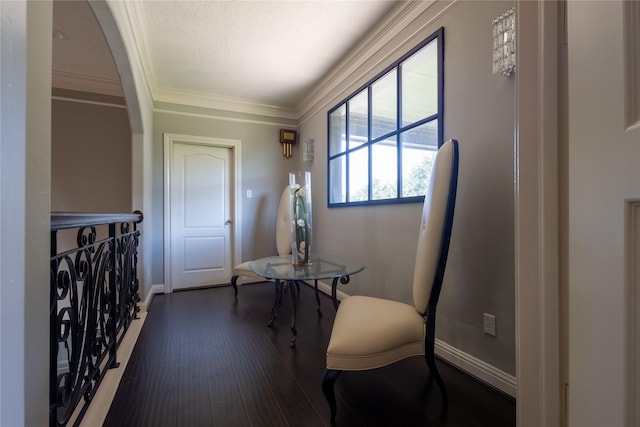 interior space featuring crown molding and dark hardwood / wood-style floors