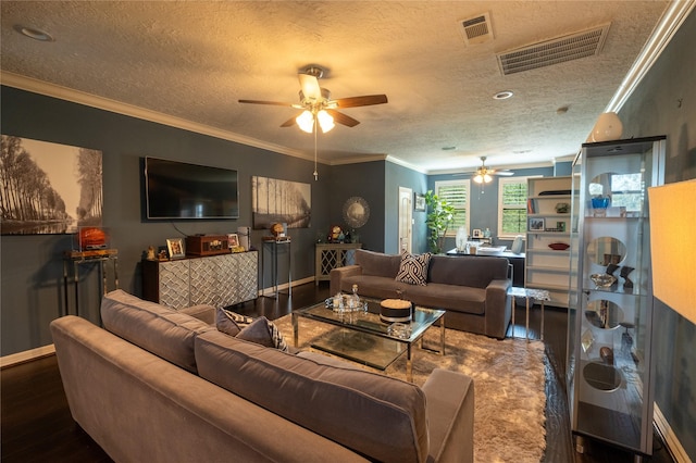 living room with a textured ceiling, dark hardwood / wood-style floors, ceiling fan, and crown molding