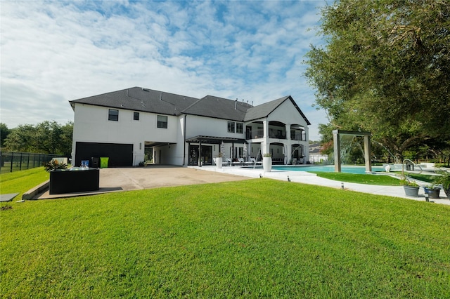 back of house featuring a patio and a lawn