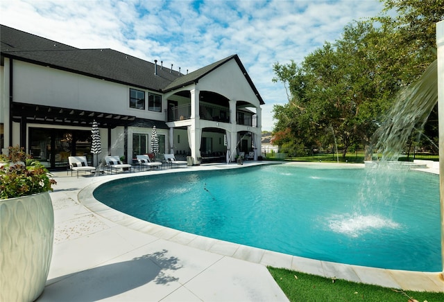 view of pool with pool water feature and a patio area