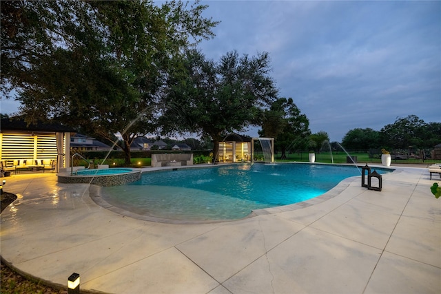 view of pool with a patio area, an in ground hot tub, and pool water feature