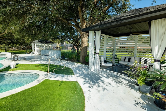 view of yard with a patio, a fenced in pool, and a storage unit