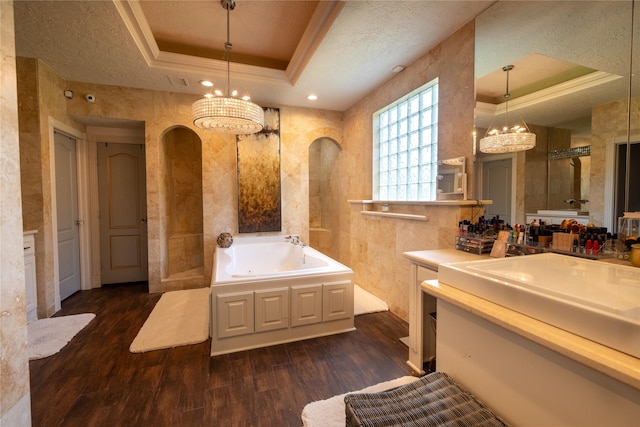 bathroom with vanity, hardwood / wood-style flooring, a raised ceiling, and independent shower and bath