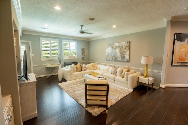 living room featuring ceiling fan, dark hardwood / wood-style flooring, a textured ceiling, and ornamental molding