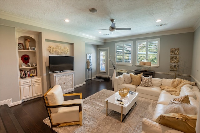 living room featuring ceiling fan, dark hardwood / wood-style flooring, a textured ceiling, and crown molding