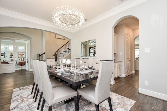 dining area with dark hardwood / wood-style flooring, a chandelier, and ornamental molding