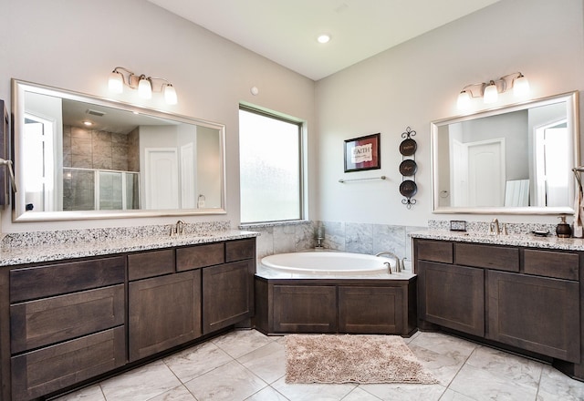 bathroom with separate shower and tub and vanity