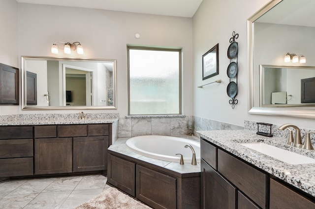 bathroom featuring a washtub and vanity