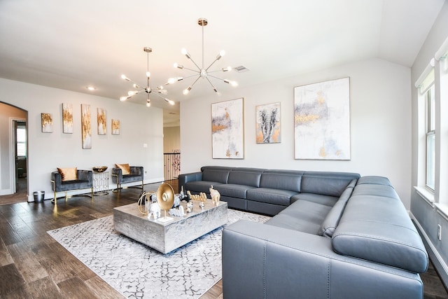 living room featuring vaulted ceiling, plenty of natural light, a chandelier, and dark hardwood / wood-style floors