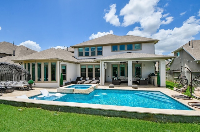 rear view of house featuring a patio area, ceiling fan, an outdoor hangout area, and a pool with hot tub