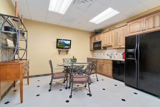 kitchen with sink, a paneled ceiling, backsplash, and black appliances