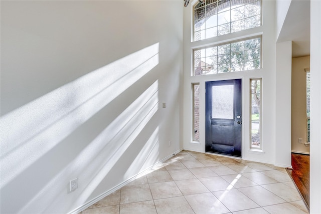 tiled foyer featuring a high ceiling