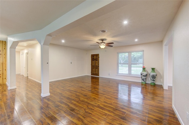 unfurnished living room featuring dark hardwood / wood-style flooring and ceiling fan