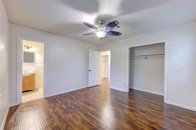 unfurnished bedroom with sink, ceiling fan, dark hardwood / wood-style floors, connected bathroom, and a closet