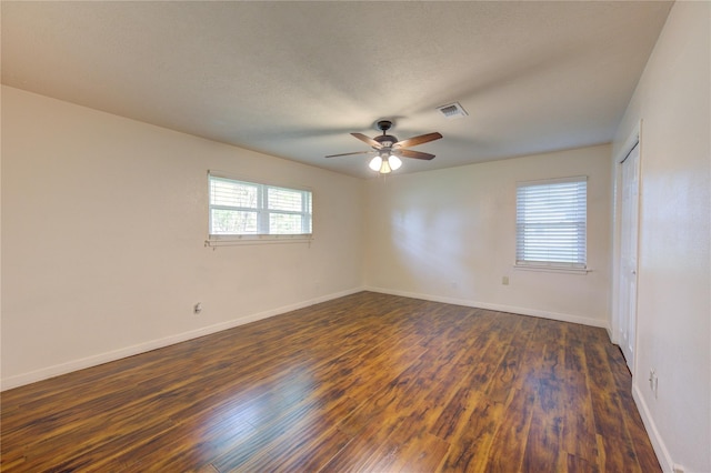 spare room featuring a textured ceiling, dark hardwood / wood-style flooring, and ceiling fan