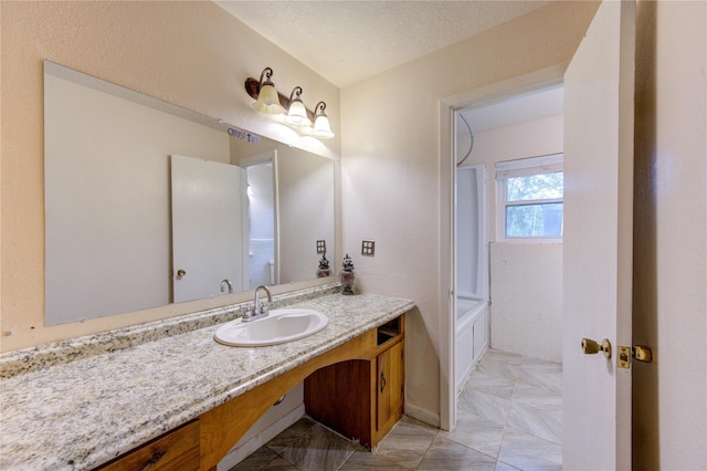 bathroom featuring vanity, a textured ceiling, and tub / shower combination