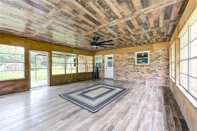 unfurnished sunroom with ceiling fan