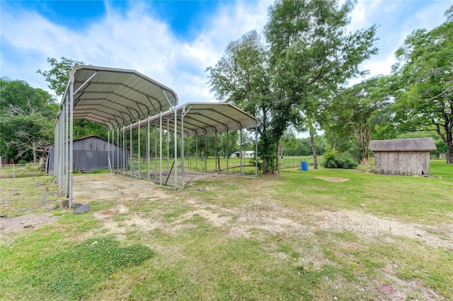 view of yard with a storage shed and a carport