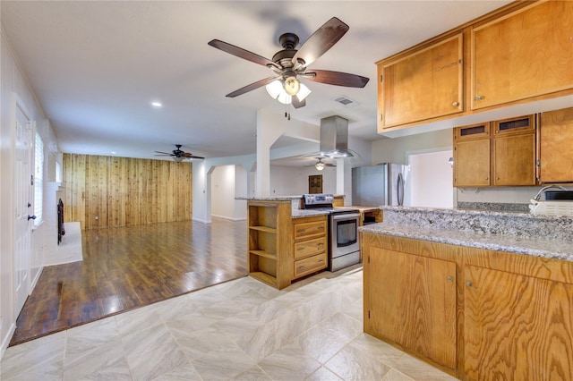 kitchen featuring kitchen peninsula, light stone countertops, stainless steel appliances, and light hardwood / wood-style flooring